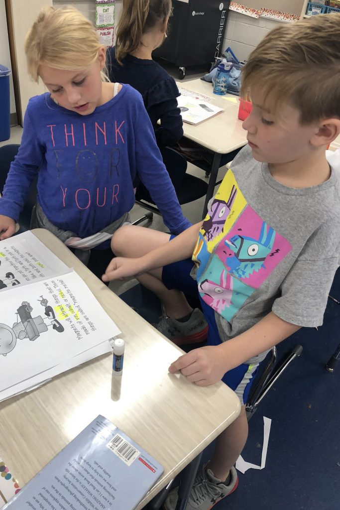 Two students looking at a book together